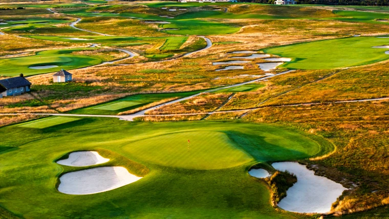 Greens, bunkers and golden fescue in the low evening light on a links-style championship course of the US Open, a mid-June engagement in the season calendar of The Mansa Court