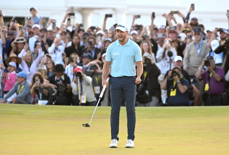 A champion roaring after the winning putt on the final green before a crowd of spectators and photographers at the US Open, the June major in the season calendar of The Mansa Court