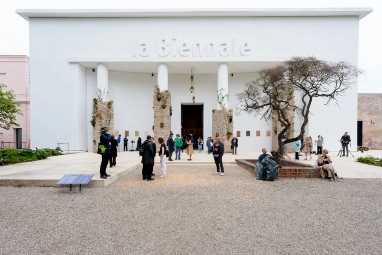 Visitors before the white façade of the Central Pavilion, lettered la Biennale, in the Giardini of the Venice Biennale, an engagement in the season calendar of The Mansa Court