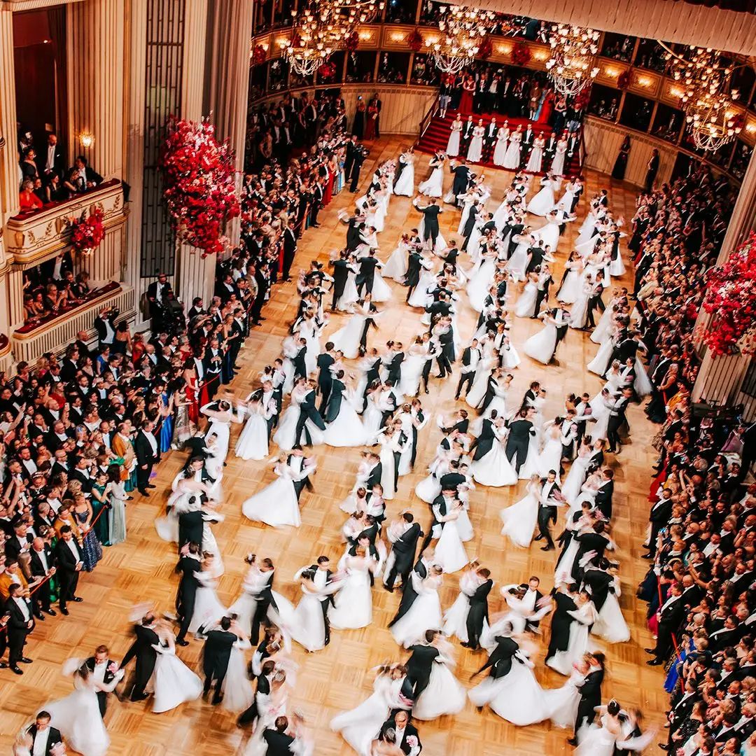 The opening waltz, white gowns and black tails turning together