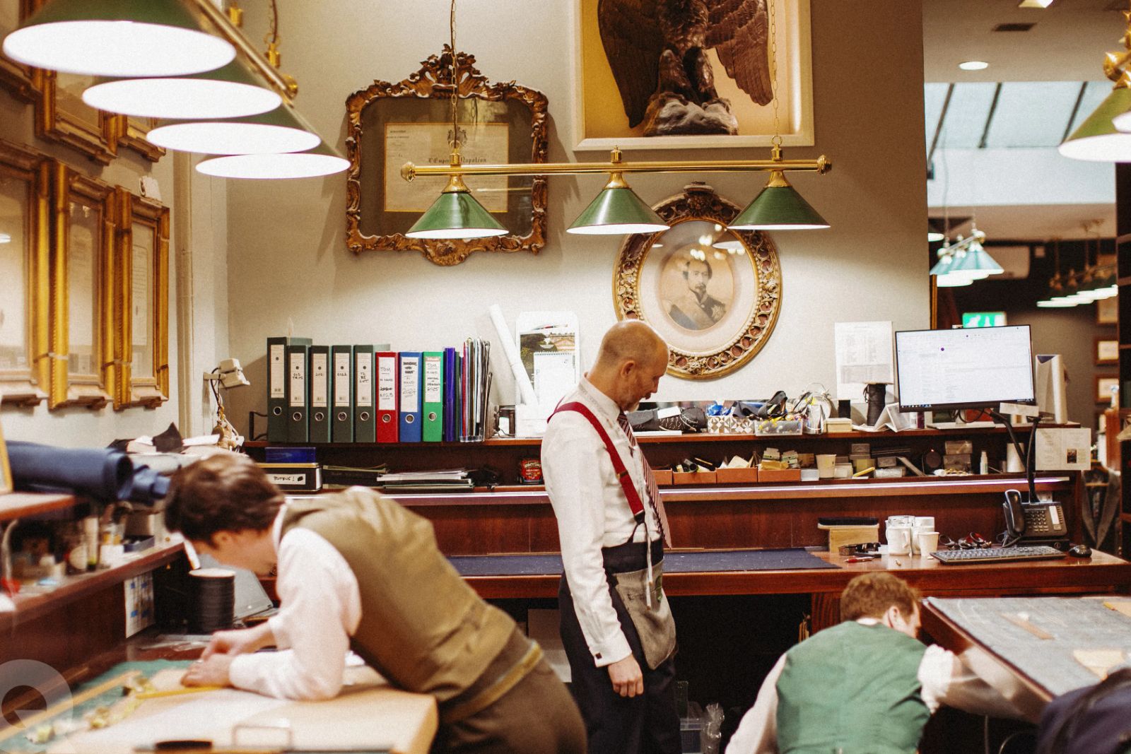 Cutters and tailors at work in a Savile Row workroom, where The Mansa Court receives a tailor and a shirtmaker for The Wardrobe in New York