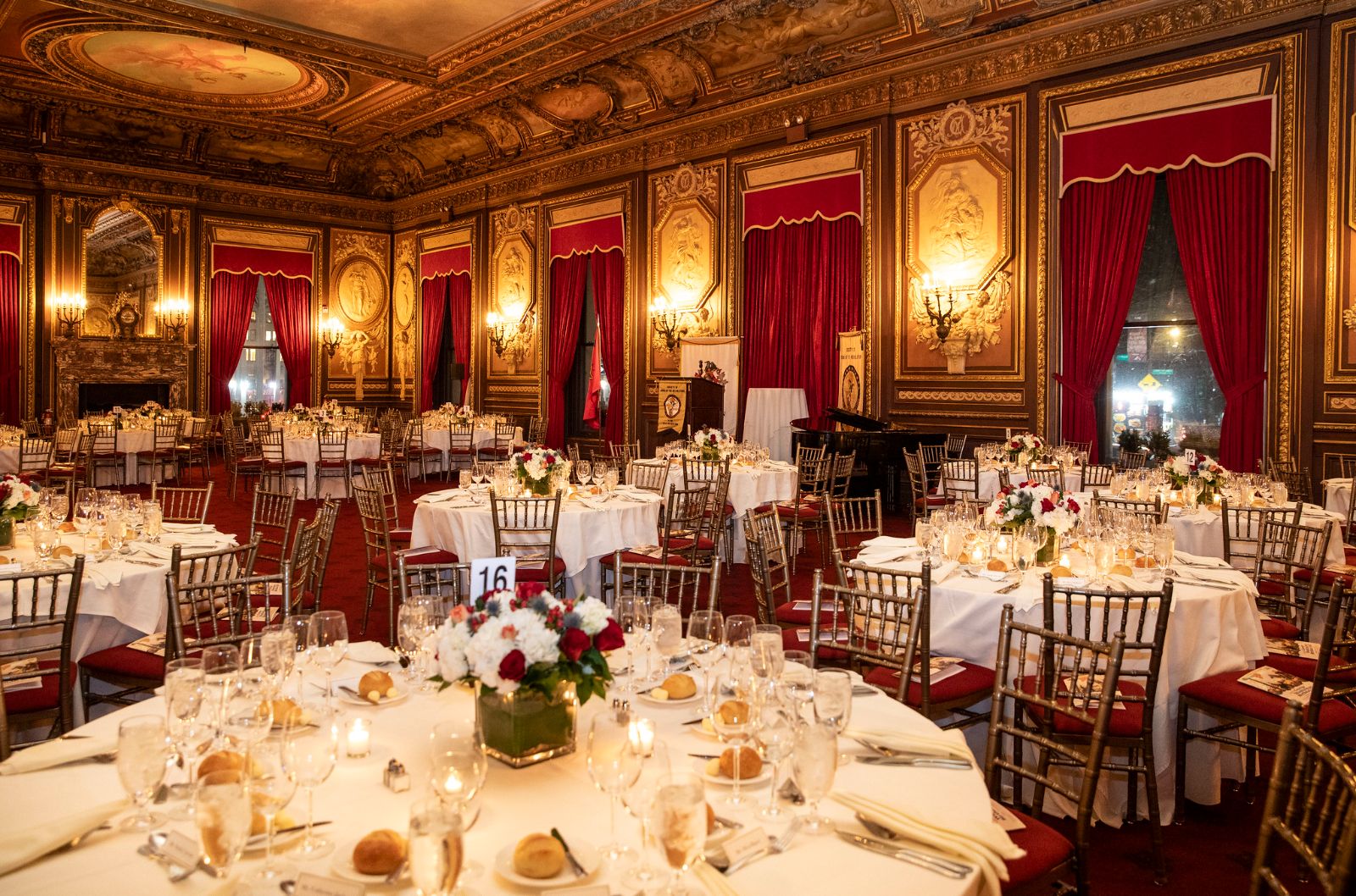 Guests in black tie at a numbered table of wheat and lilies during dinner at The Washington Birthday Ball