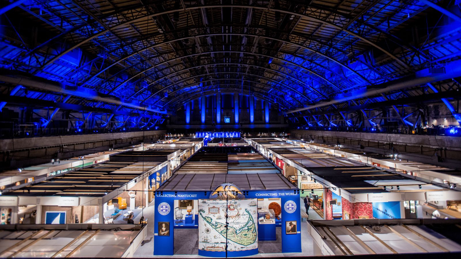 Dealers' stands under the vaulted drill hall of the Park Avenue Armory at the Winter Show