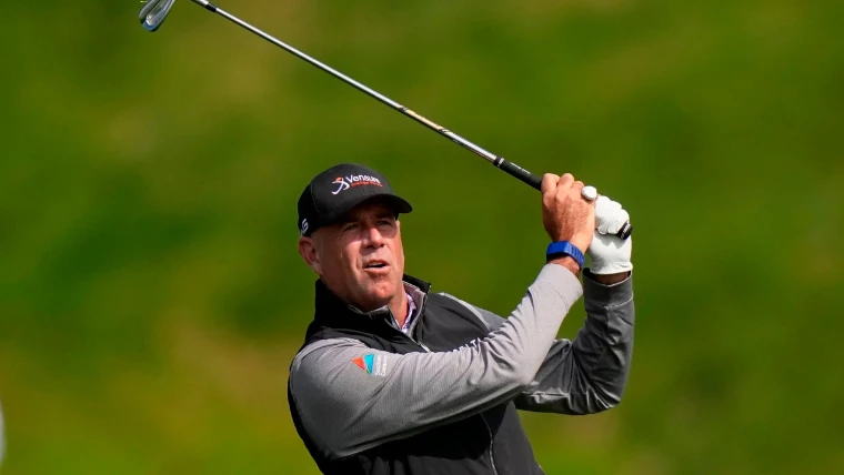 A player follows the flight of an iron shot during a round, in 2026. The PGA Championship, at US PGA Championship, in the season calendar of The Mansa Court