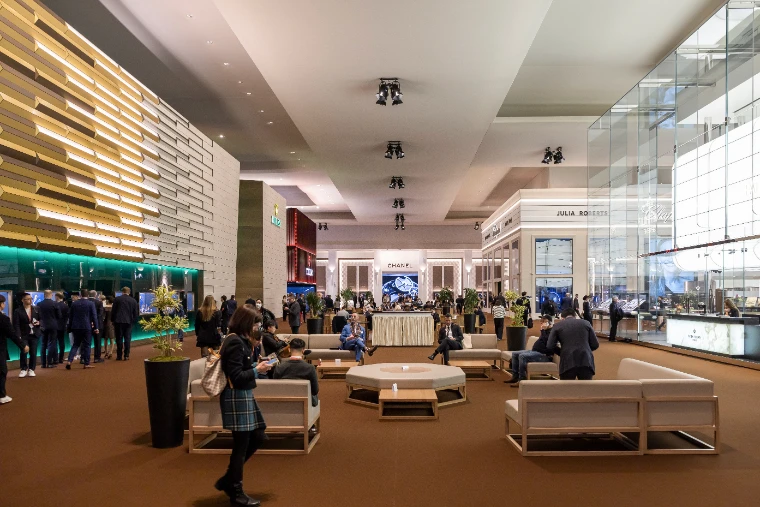Visitors in the lounge of the Palexpo hall between the Rolex, Chanel and Patek Philippe stands at Watches and Wonders Geneva, a mid-April engagement in the season calendar of The Mansa Court