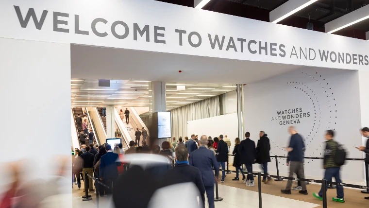 Visitors passing beneath the welcome sign at the entrance to the fair at Watches and Wonders Geneva, a mid-April engagement in the season calendar of The Mansa Court